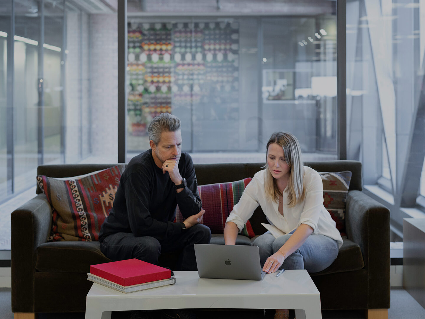 Man and woman reviewing work in office setting