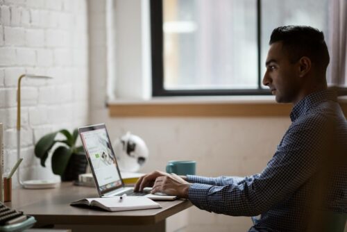 Man Working With Laptop Open 1